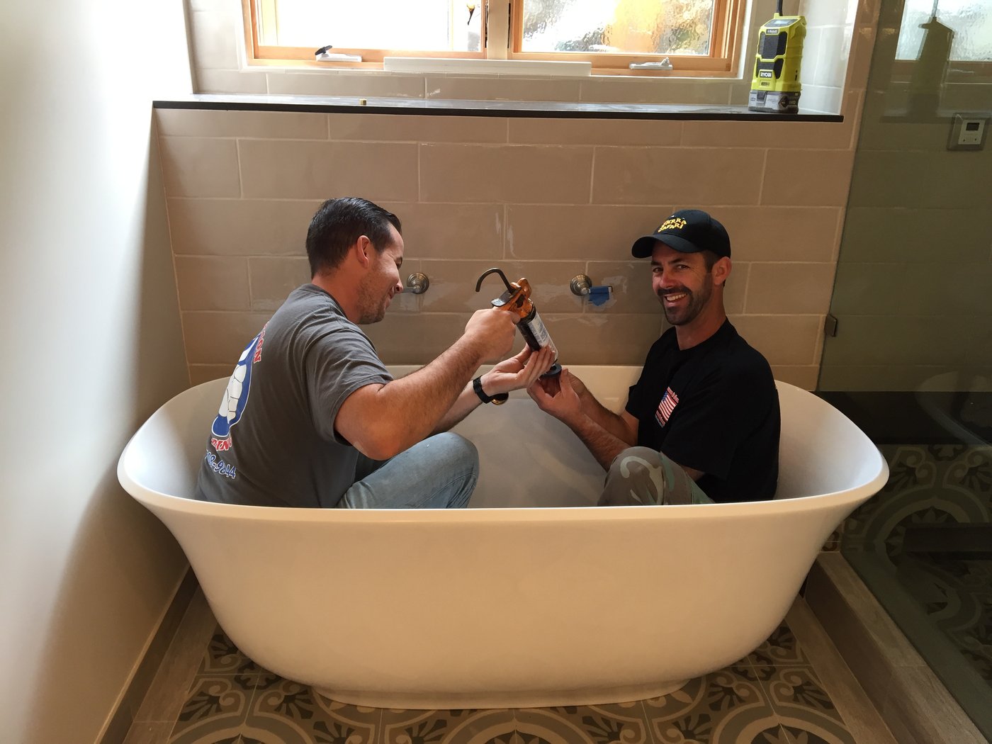 Klemann & Son Plumbing crew installing a faucet during a bathroom remodel